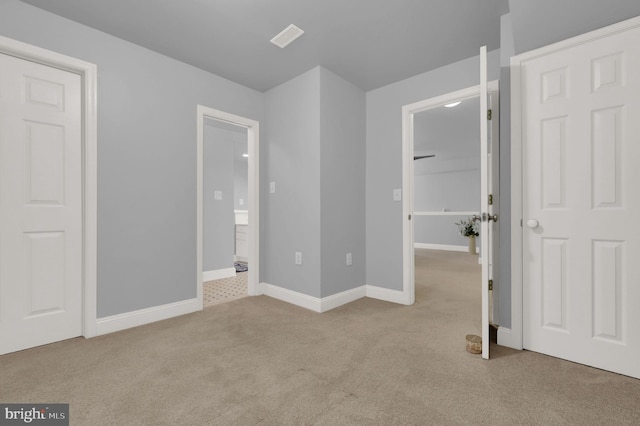 unfurnished bedroom featuring light colored carpet