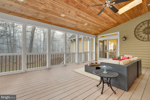 sunroom with ceiling fan, wood ceiling, a healthy amount of sunlight, and vaulted ceiling with skylight