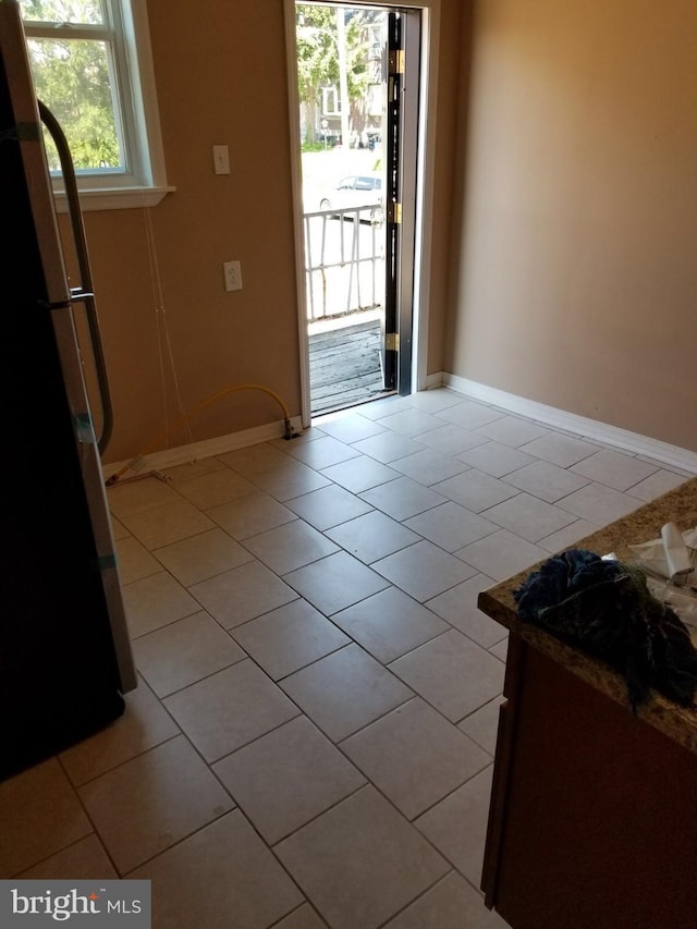 doorway to outside featuring light tile patterned flooring