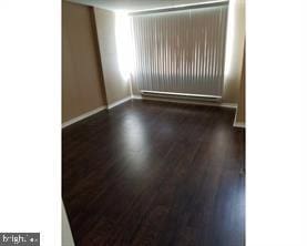 spare room featuring dark hardwood / wood-style flooring