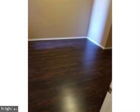 unfurnished room featuring dark hardwood / wood-style floors