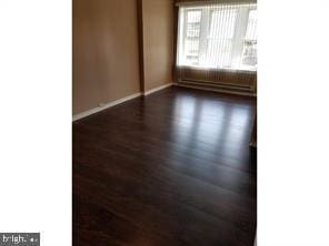 spare room featuring dark wood-type flooring