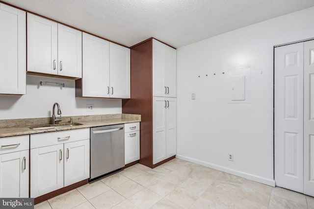 kitchen featuring dishwasher, white cabinets, and sink