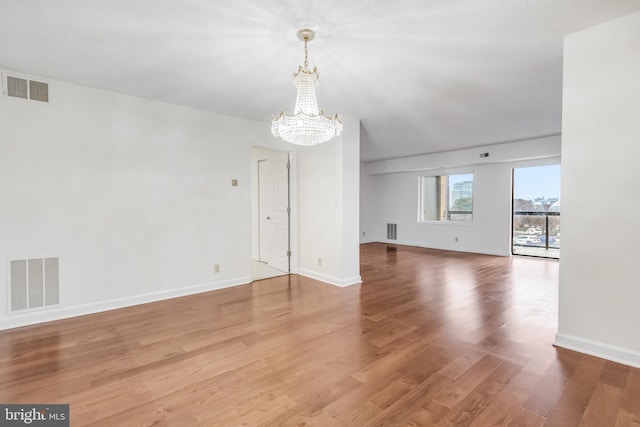 interior space featuring hardwood / wood-style floors and a notable chandelier