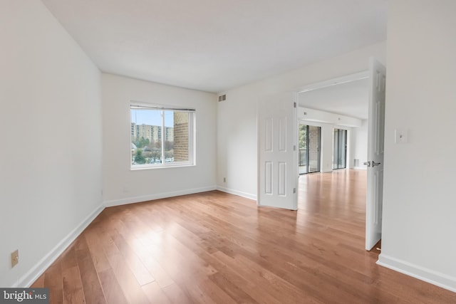 unfurnished room featuring light hardwood / wood-style floors