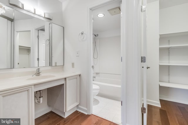 full bathroom featuring shower / tub combination, hardwood / wood-style floors, vanity, and toilet