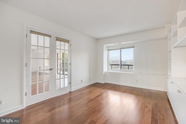 unfurnished room featuring french doors and wood-type flooring