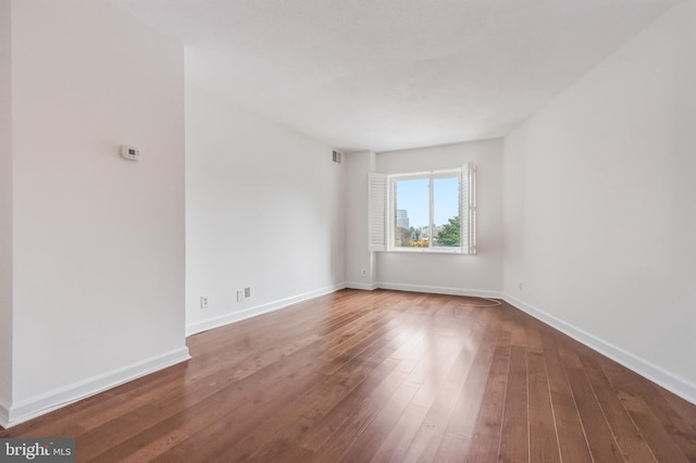 spare room with hardwood / wood-style floors