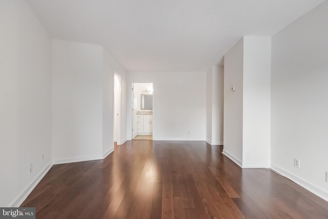 unfurnished room featuring dark wood-type flooring