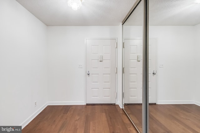 entrance foyer featuring hardwood / wood-style floors and a textured ceiling