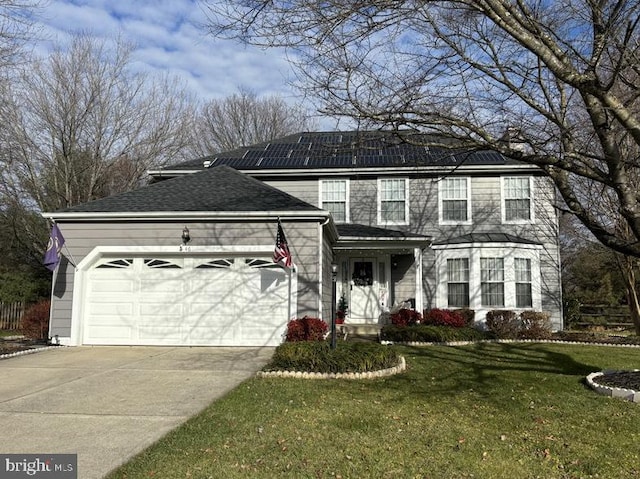 view of front facade featuring a front yard and a garage