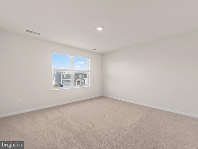 unfurnished room with light colored carpet