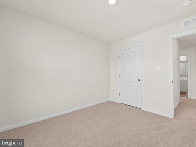 unfurnished bedroom with light colored carpet