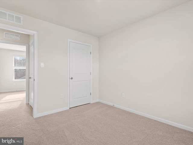 unfurnished bedroom with light colored carpet