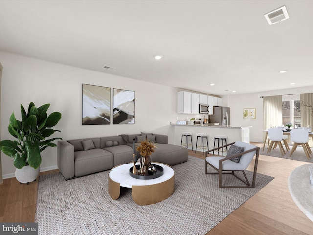 living room with light hardwood / wood-style floors