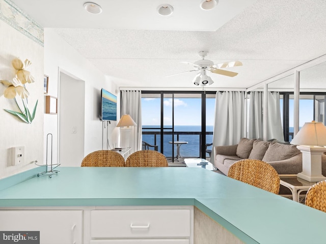 kitchen with ceiling fan and a textured ceiling