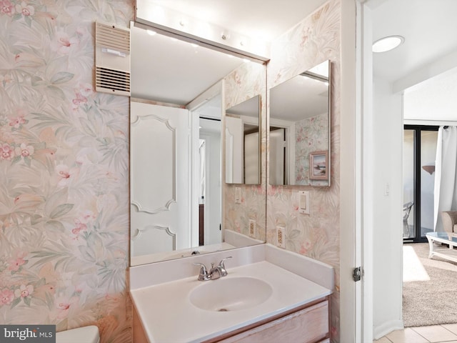 bathroom featuring tile patterned flooring and vanity