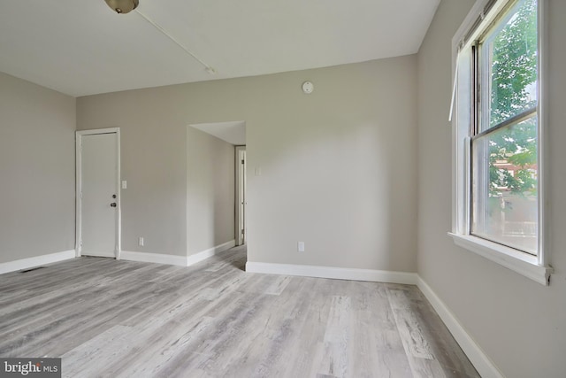 empty room with light hardwood / wood-style flooring