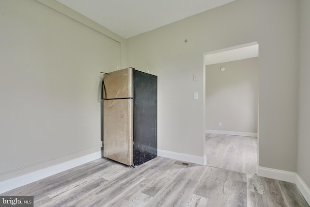 spare room featuring light wood-type flooring