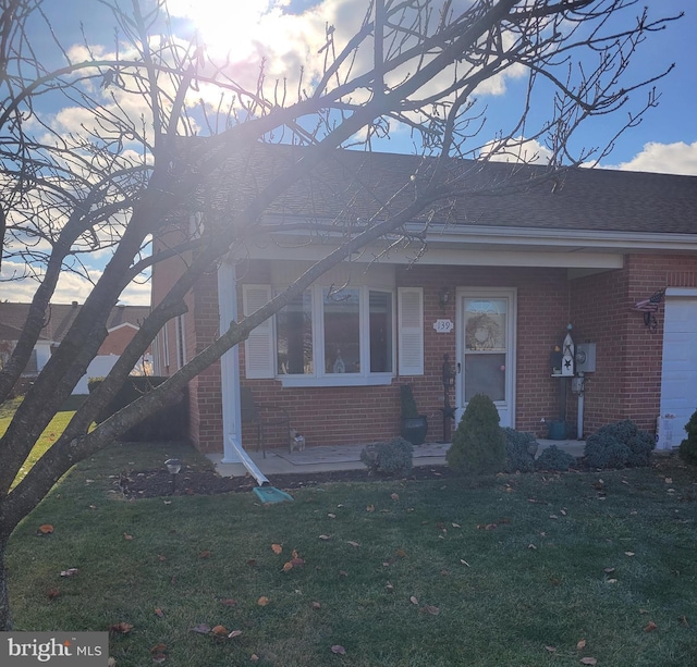 view of front of home with a yard and a garage