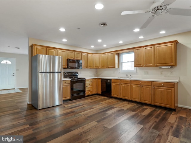 kitchen featuring black appliances, ceiling fan, sink, and dark wood-type flooring