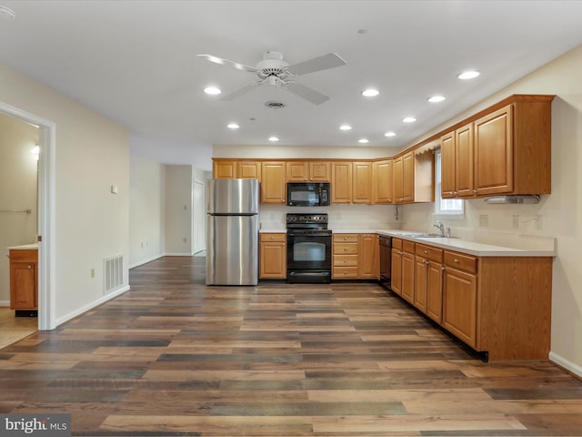 kitchen with black appliances, ceiling fan, sink, and dark wood-type flooring