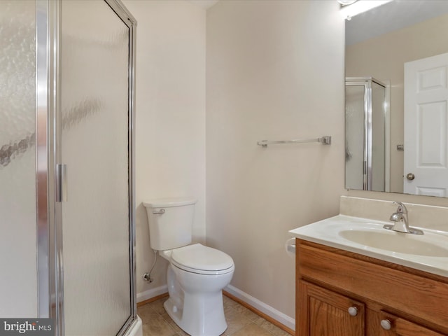 bathroom with tile patterned floors, a shower with door, vanity, and toilet