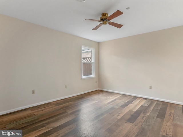 empty room featuring ceiling fan and dark wood-type flooring