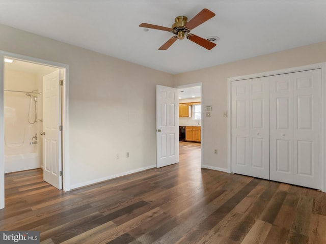 unfurnished bedroom featuring a closet, connected bathroom, ceiling fan, and dark hardwood / wood-style flooring