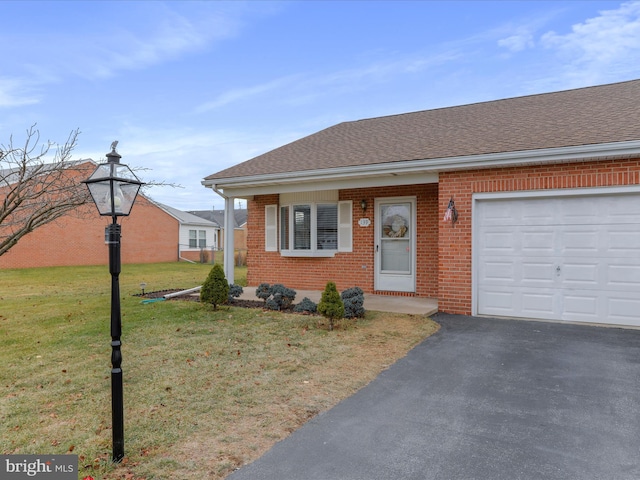 view of front of property with a front yard and a garage