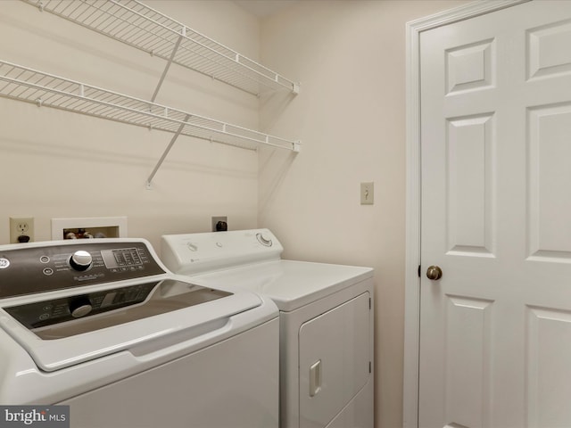 clothes washing area featuring washing machine and clothes dryer