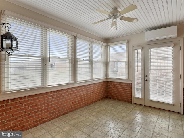 unfurnished sunroom featuring a wall unit AC and ceiling fan