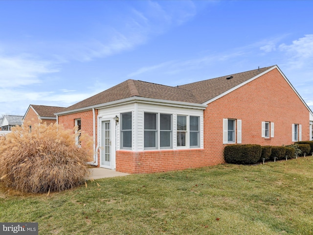 view of home's exterior with a yard