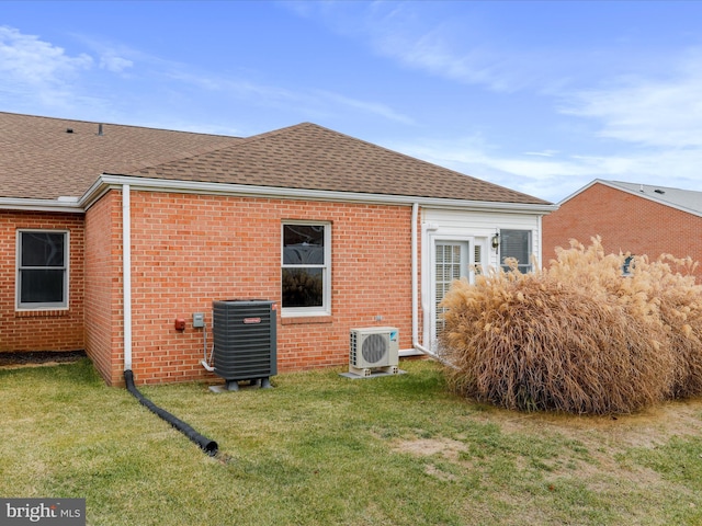 back of house with a lawn, ac unit, and cooling unit