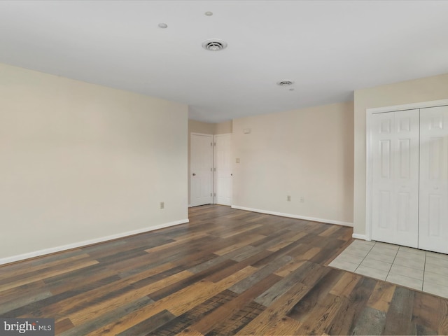 unfurnished room with dark hardwood / wood-style floors