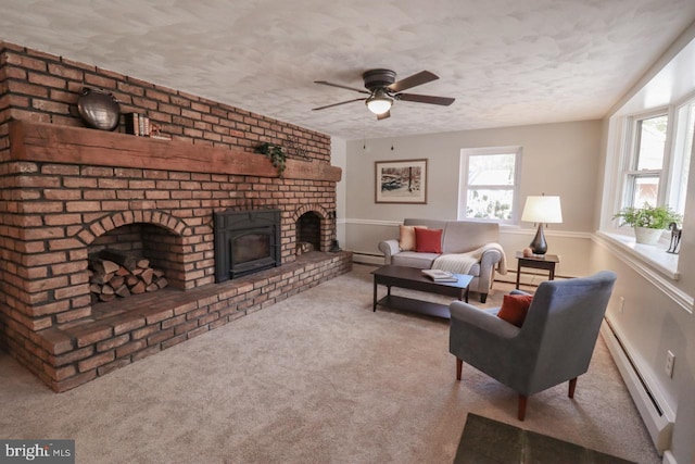 6381 Glatfelters Station Rd, Seven Valleys, PA 17360 - living area with a baseboard heating unit, plenty of natural light, carpet floors, a fireplace, and a textured ceiling