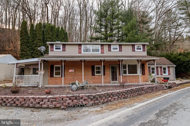 6381 Glatfelters Station Rd, Seven Valleys, PA 17360 - traditional home featuring covered porch and brick siding