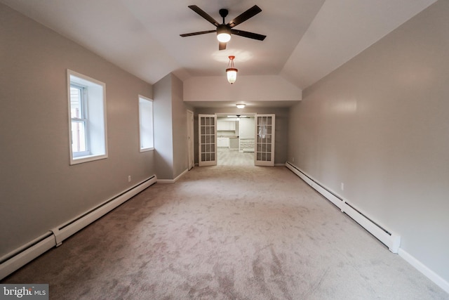 interior space with carpet flooring, french doors, vaulted ceiling, and a baseboard heating unit