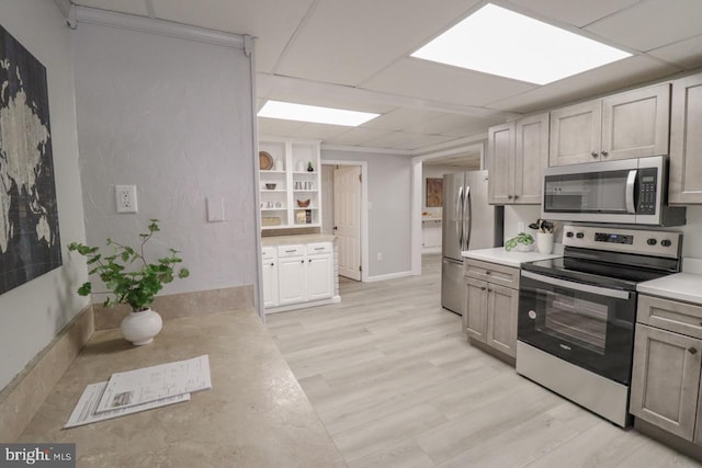 6381 Glatfelters Station Rd, Seven Valleys, PA 17360 - kitchen featuring appliances with stainless steel finishes, light countertops, a drop ceiling, and light wood-type flooring