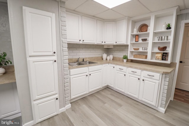 6381 Glatfelters Station Rd, Seven Valleys, PA 17360 - kitchen featuring a sink, open shelves, light wood-style flooring, light countertops, and white cabinetry