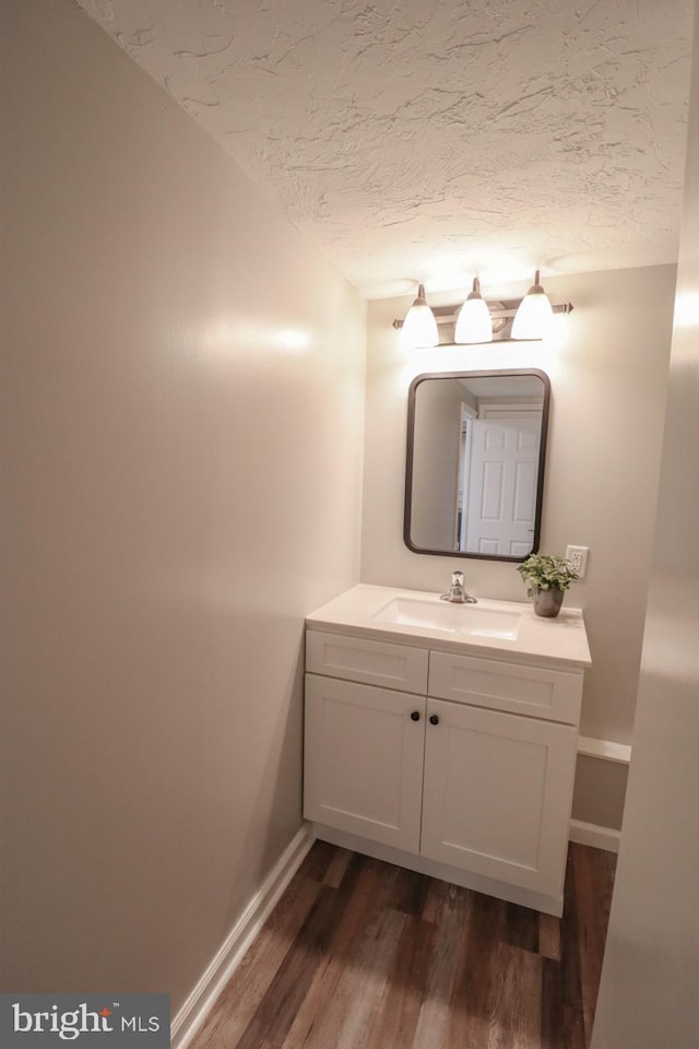 6381 Glatfelters Station Rd, Seven Valleys, PA 17360 - bathroom featuring baseboards, wood finished floors, vanity, and a textured ceiling