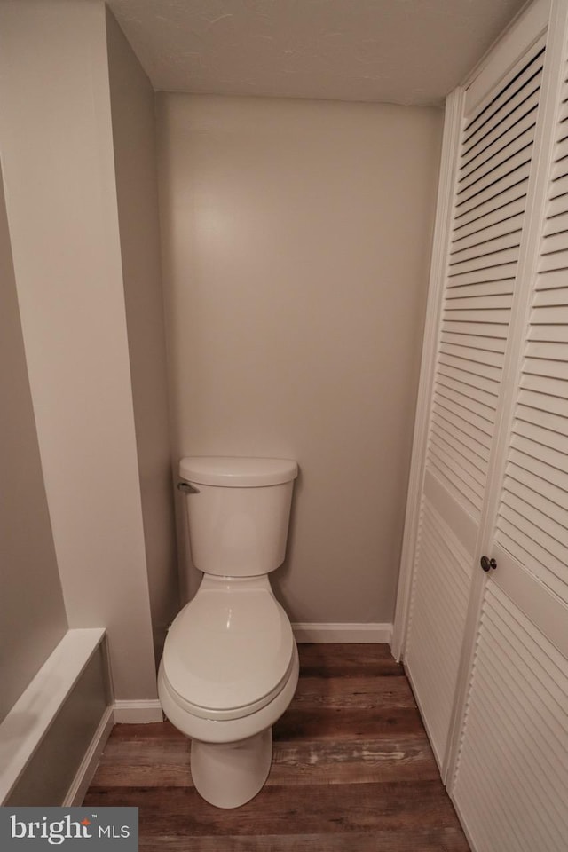6381 Glatfelters Station Rd, Seven Valleys, PA 17360 - bathroom with wood finished floors, baseboards, toilet, and a closet