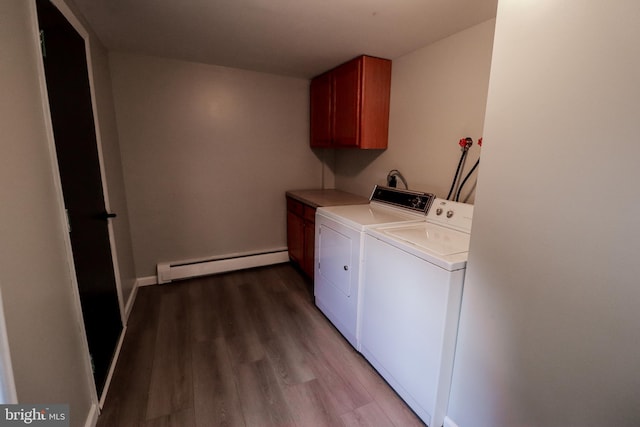 laundry area with hardwood / wood-style floors, washer and dryer, cabinets, and baseboard heating