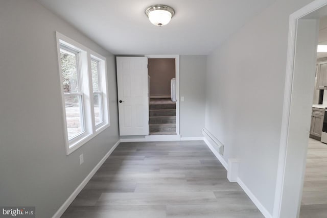 6381 Glatfelters Station Rd, Seven Valleys, PA 17360 - hall with light wood-style floors, baseboards, stairway, and baseboard heating