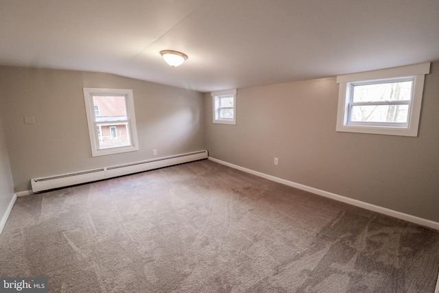 basement with carpet, plenty of natural light, and baseboard heating