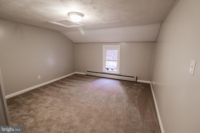 additional living space featuring a textured ceiling, carpet floors, vaulted ceiling, and a baseboard heating unit