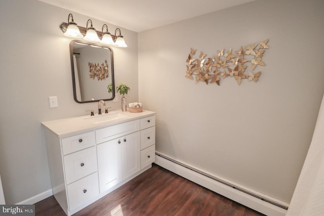 6381 Glatfelters Station Rd, Seven Valleys, PA 17360 - bathroom featuring baseboard heating, vanity, and wood finished floors