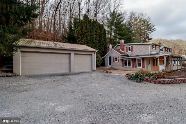 6381 Glatfelters Station Rd, Seven Valleys, PA 17360 - view of front of home with a detached garage, an outbuilding, and a chimney