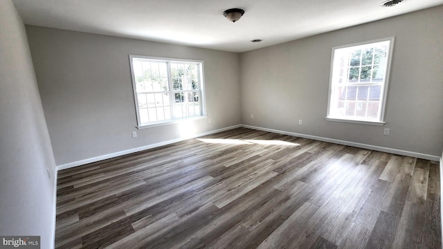 unfurnished room with dark hardwood / wood-style floors