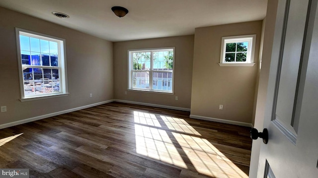 spare room with dark hardwood / wood-style floors